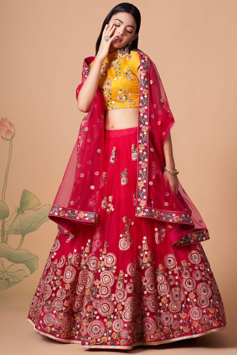 Dazzling Sangeet Wear Rani Color Lehenga Choli In Net Fabric