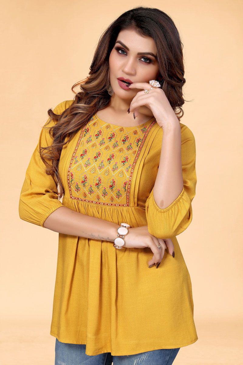 Embroidered Designs On Mustard Color Short Kurti In Rayon Fabric