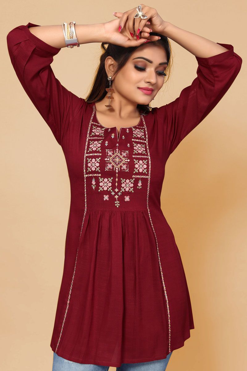 Beguiling Embroidered Work On Maroon Color Rayon Fabric Short Kurti